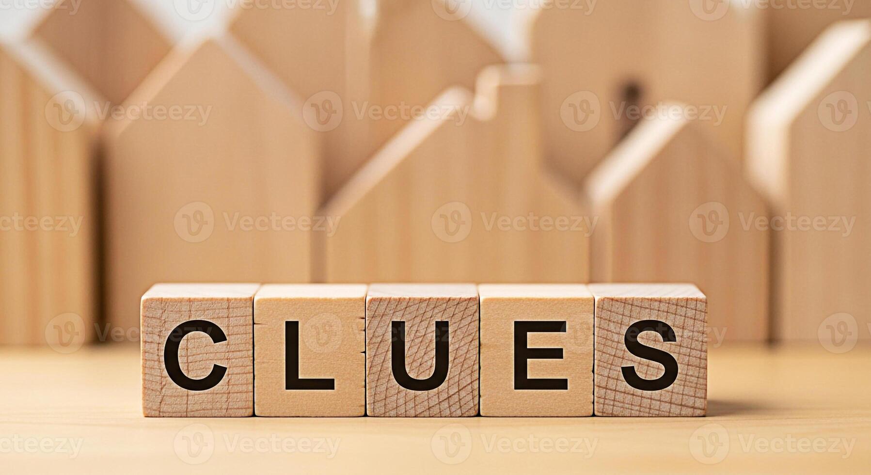 Wooden blocks spelling CLUES on a wooden surface surrounded by blurred wooden house shapes symbolizing investigation problemsolving and the search for answers in a conceptual and minimalist setting photo