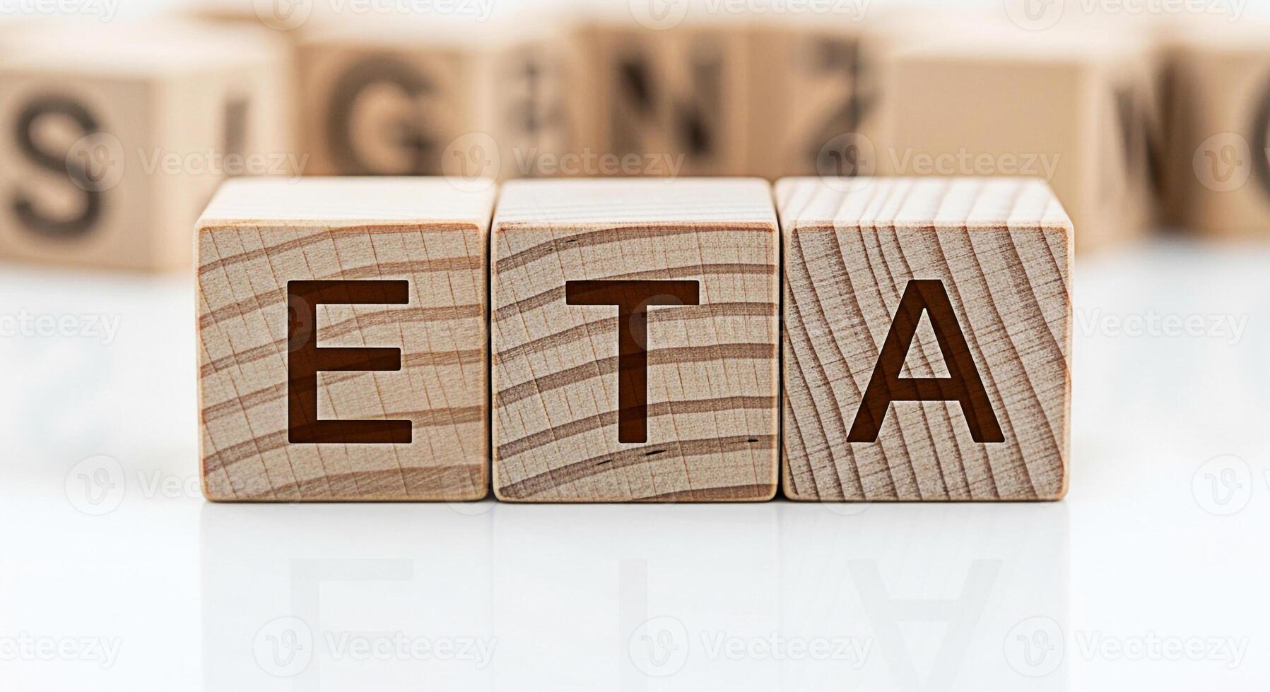 Wooden blocks displaying the letters ETA on a white surface representing Estimated Time of Arrival in a business setting conveying a sense of expectation and planning for project management and logist photo