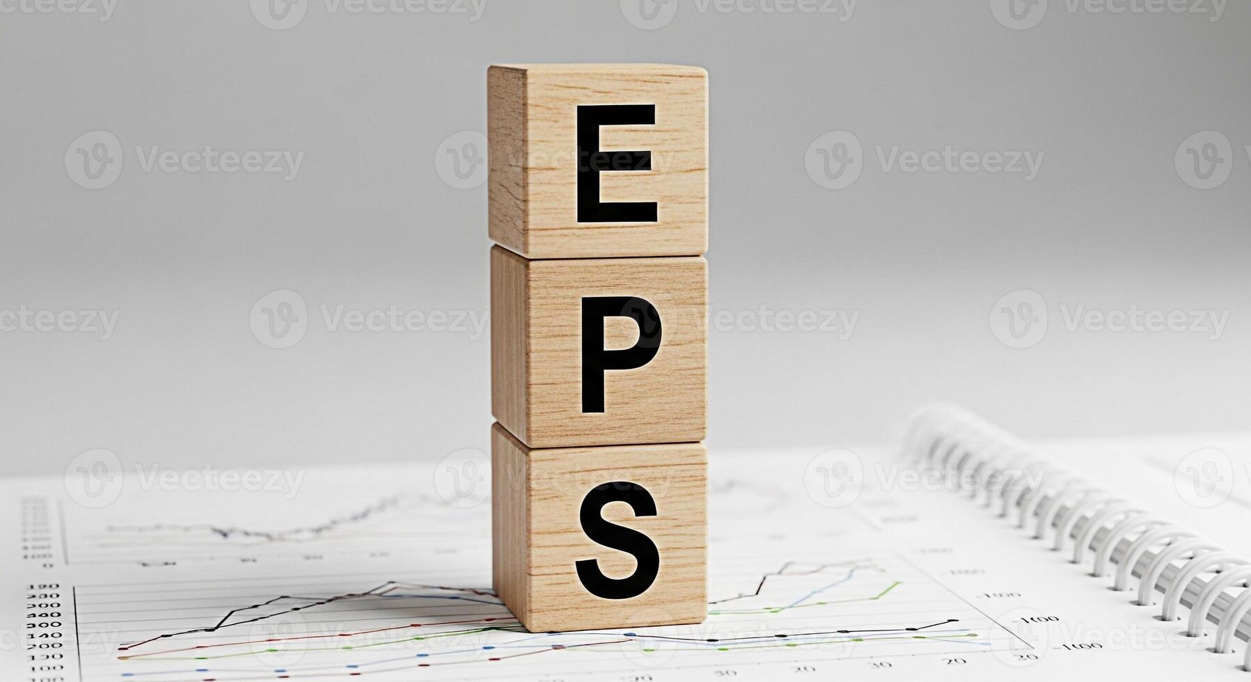 Wooden blocks displaying EPS on a financial report symbolizing earnings per share in a business setting conveying a message of financial analysis and investment strategy for stock market success photo