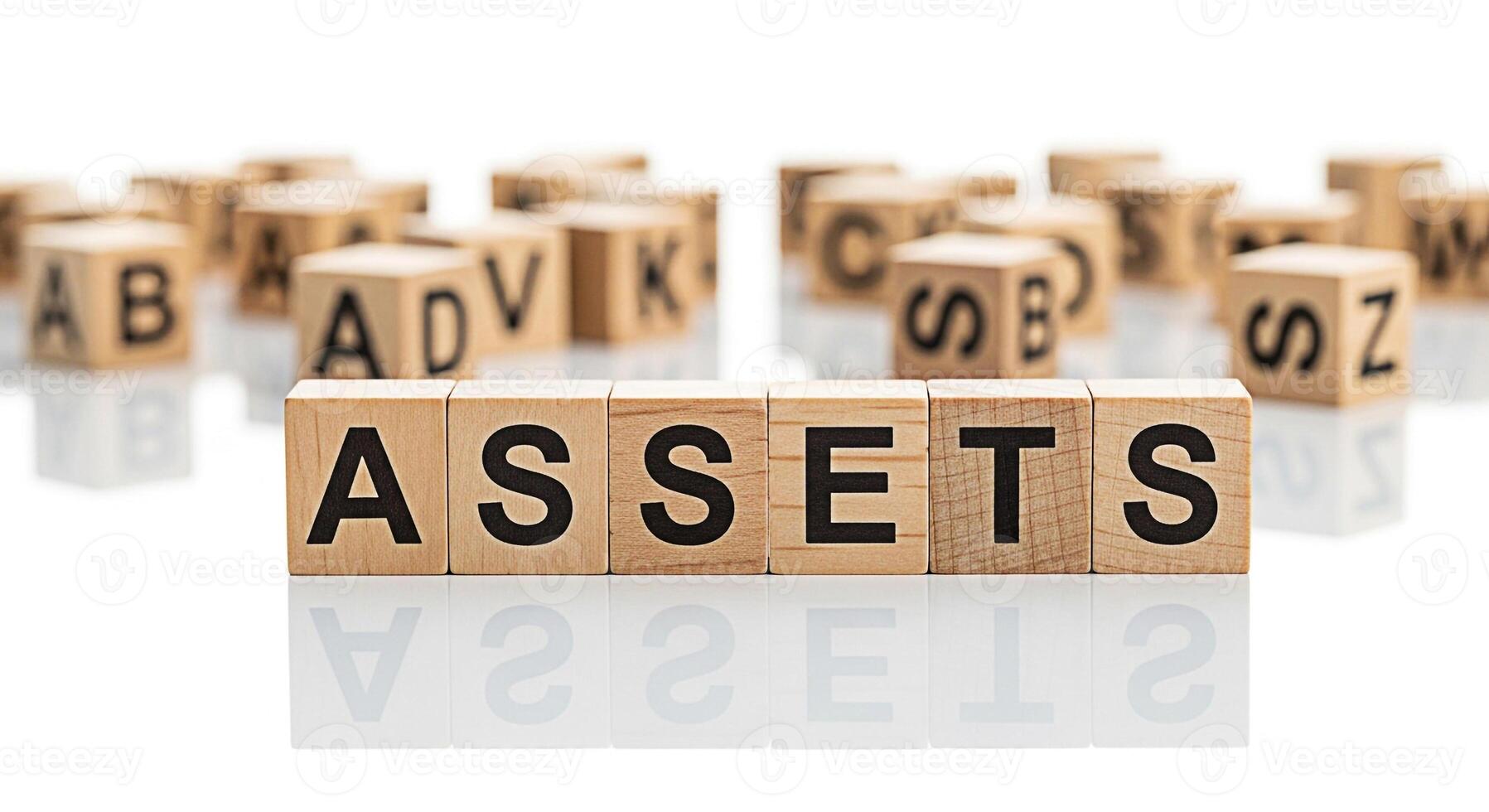 Wooden blocks spelling ASSETS on a reflective white surface representing financial security and investment conveying a sense of stability and wealth management in a clean minimalist setting photo