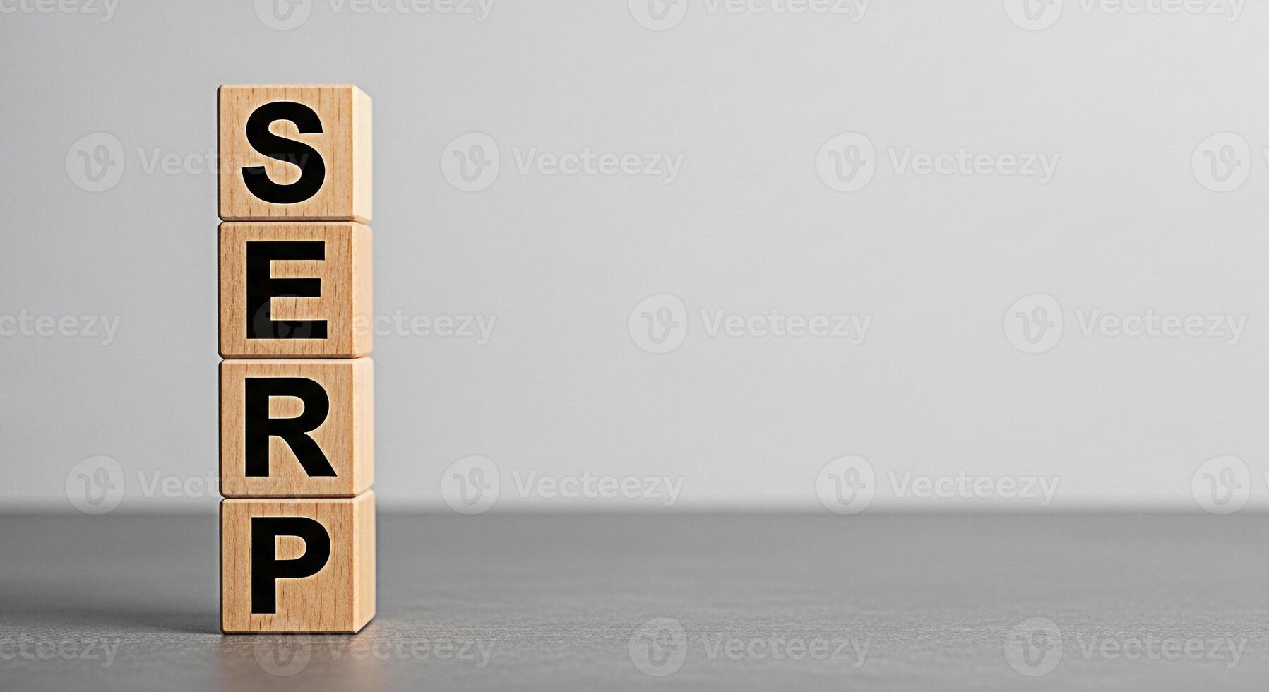 Wooden blocks displaying SERP on a gray surface representing search engine results page optimization conveying a message of online visibility and strategic digital marketing success photo