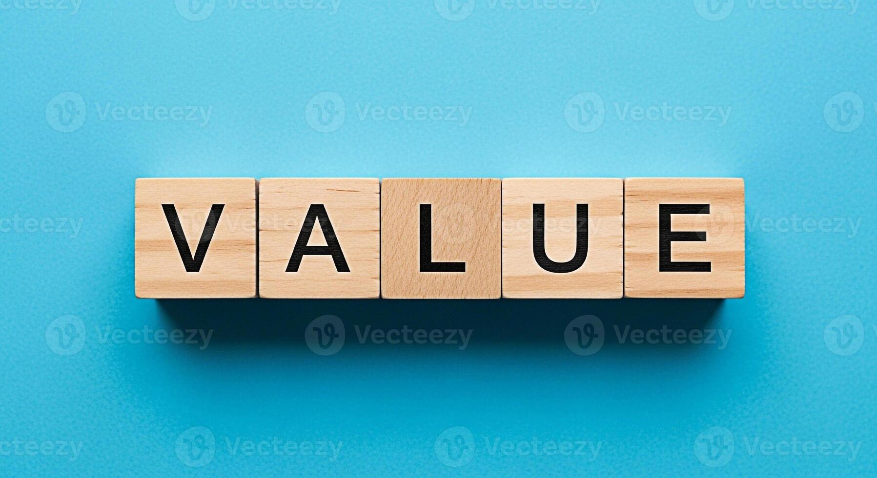 Wooden blocks spelling out VALUE on a vibrant blue background representing the core values and importance of business ethics and financial success creating a sense of trust and reliability photo