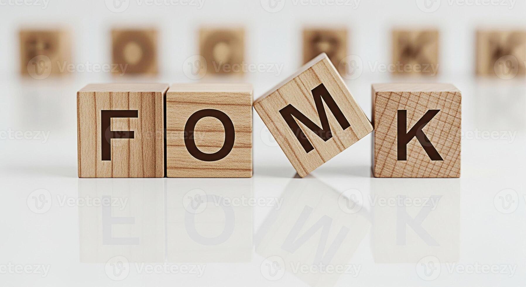 Wooden blocks spelling FOMO and OK on a white reflective surface representing the fear of missing out and acceptance conveying a message of balance and wellbeing in a minimalist setting photo