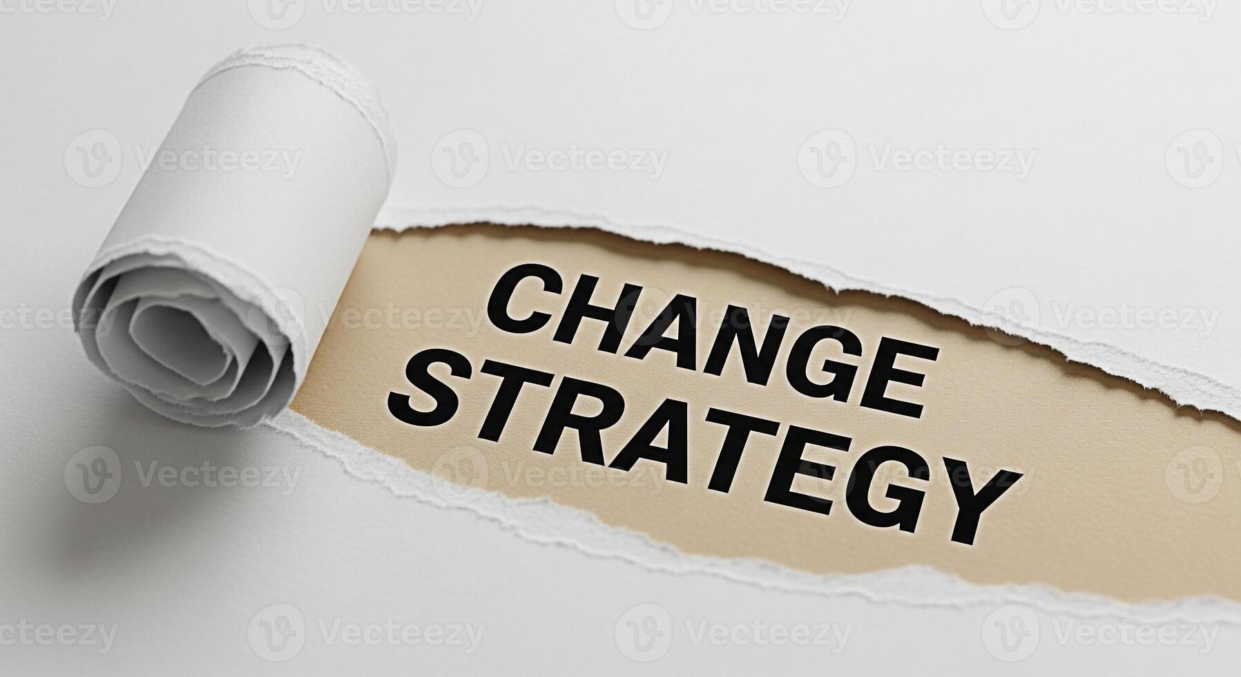 Torn paper revealing the words Change Strategy on a beige background symbolizing a shift in business approach and a fresh perspective for future growth and innovation in a competitive market photo
