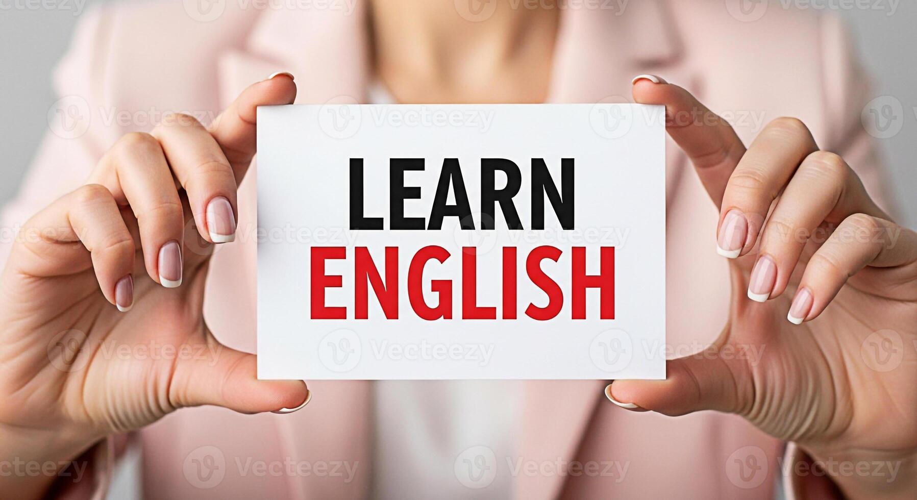 Elegant woman in a professional setting holding a card that says Learn English conveying a message of education and selfimprovement ideal for language learning and personal development promotions photo