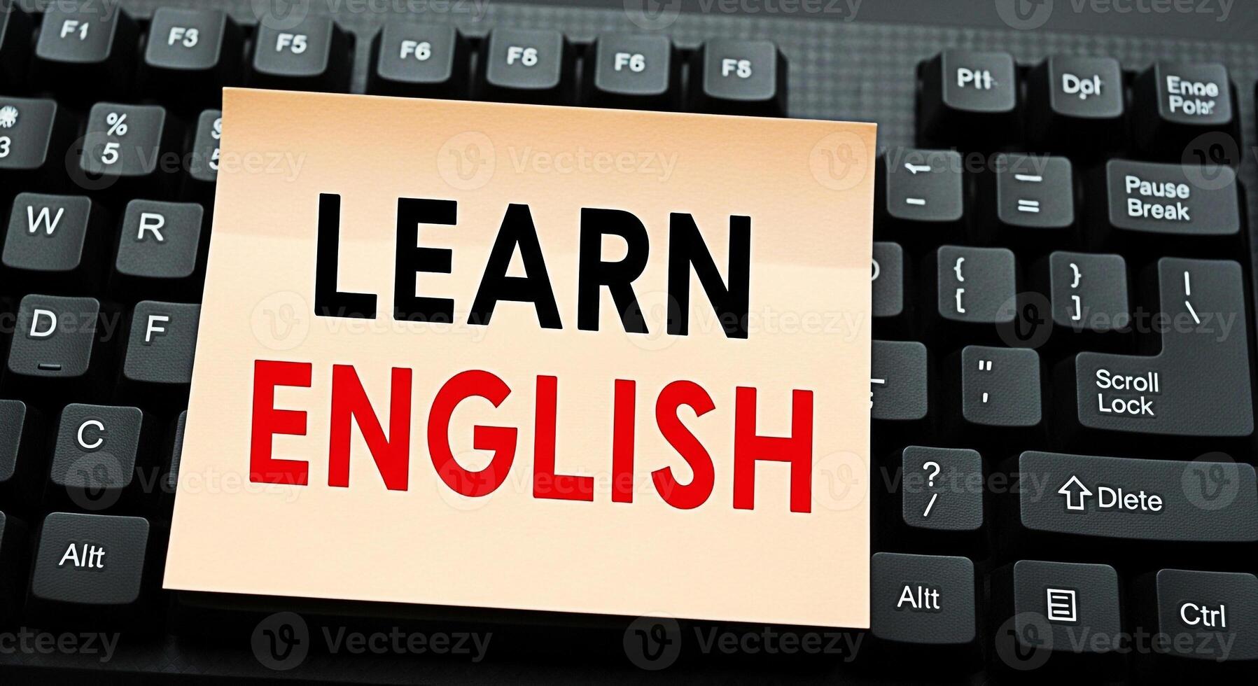 Closeup of a sticky note with the words Learn English placed on a black computer keyboard symbolizing language acquisition and educational opportunities in a digital learning environment fostering a p photo