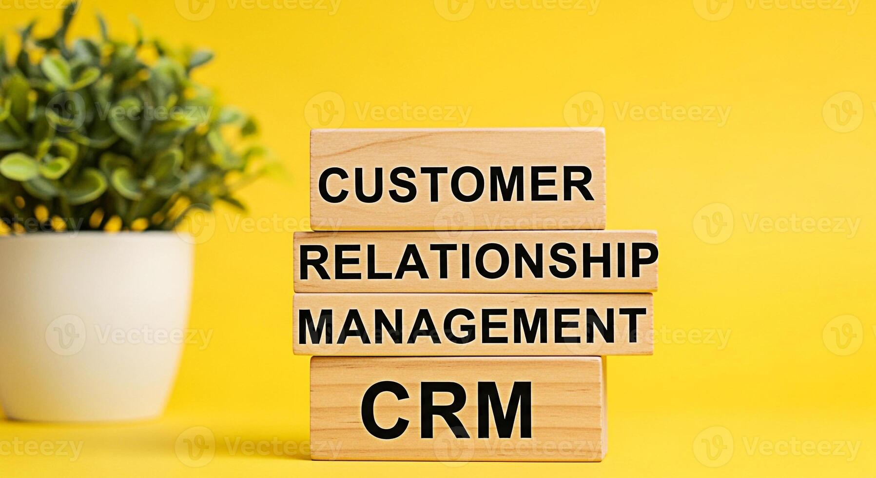 Wooden blocks displaying Customer Relationship Management CRM on a vibrant yellow background symbolizing effective business strategies and customercentric approaches in a modern business environment photo