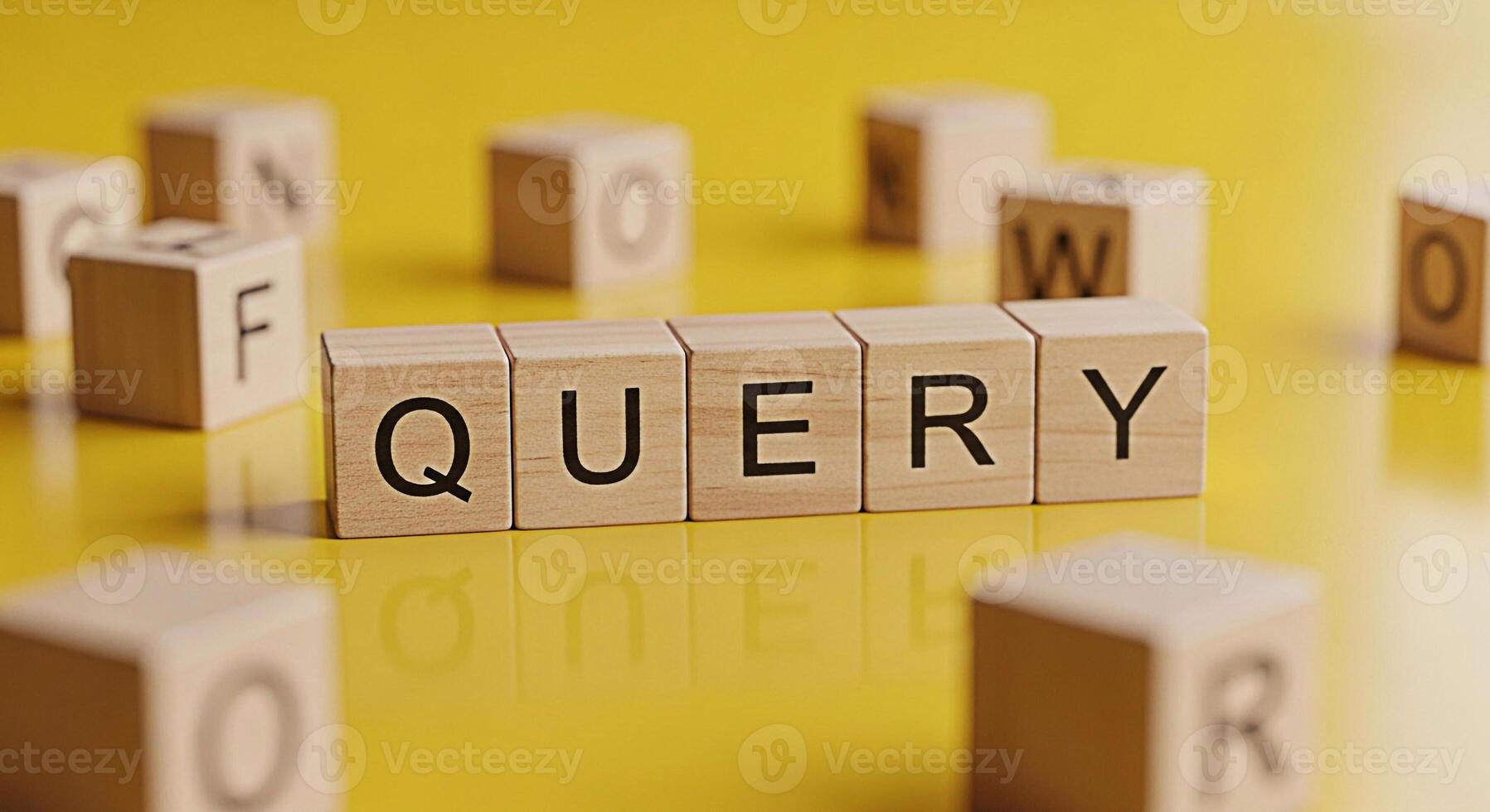 Wooden blocks spelling QUERY on a reflective yellow surface surrounded by scattered letter blocks representing information retrieval and search queries in a bright minimalist setting conveying clarity photo