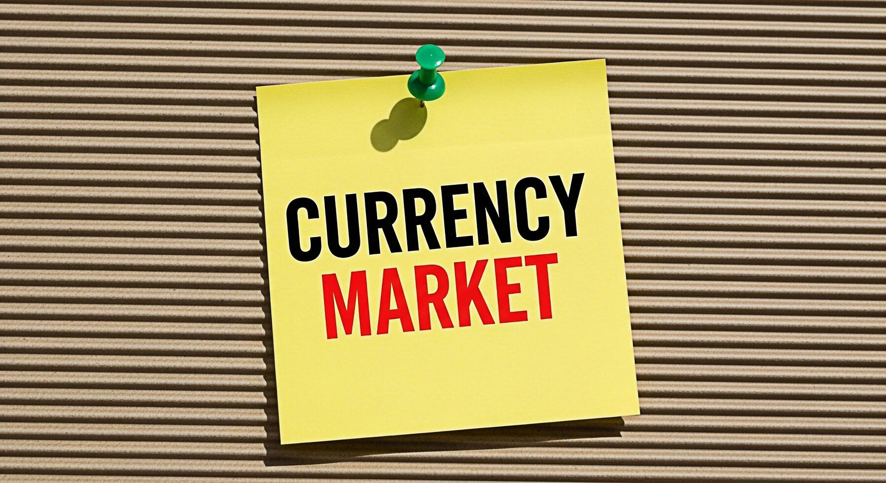 Bright yellow sticky note displaying Currency Market pinned on a corrugated cardboard surface conveying a message about financial trading and global economics in a simple yet impactful way symbolizing photo
