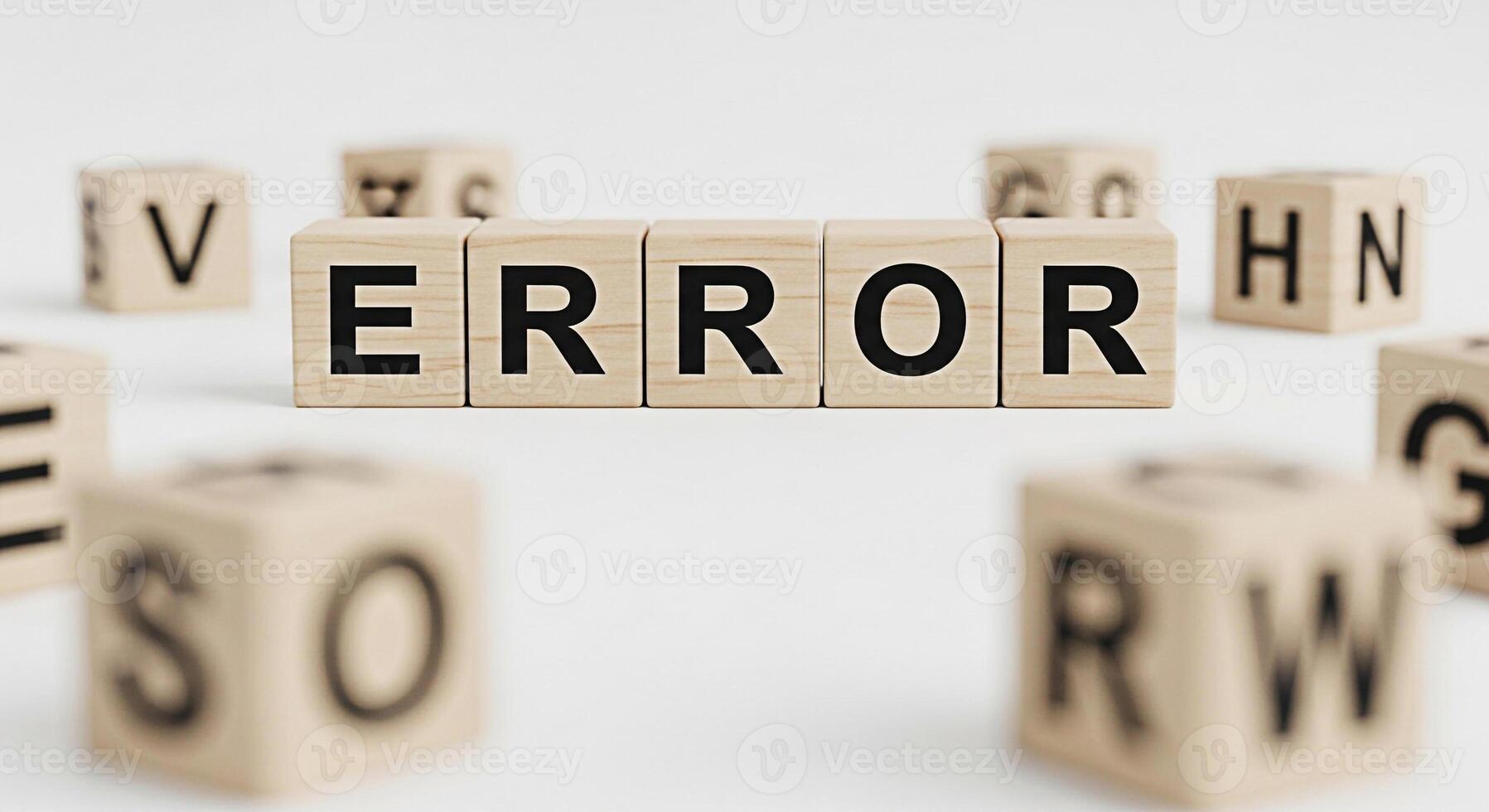 Wooden blocks spelling out ERROR on a white surface surrounded by other lettered blocks symbolizing a system failure technical problem or programming bug in a clean minimalist setting photo