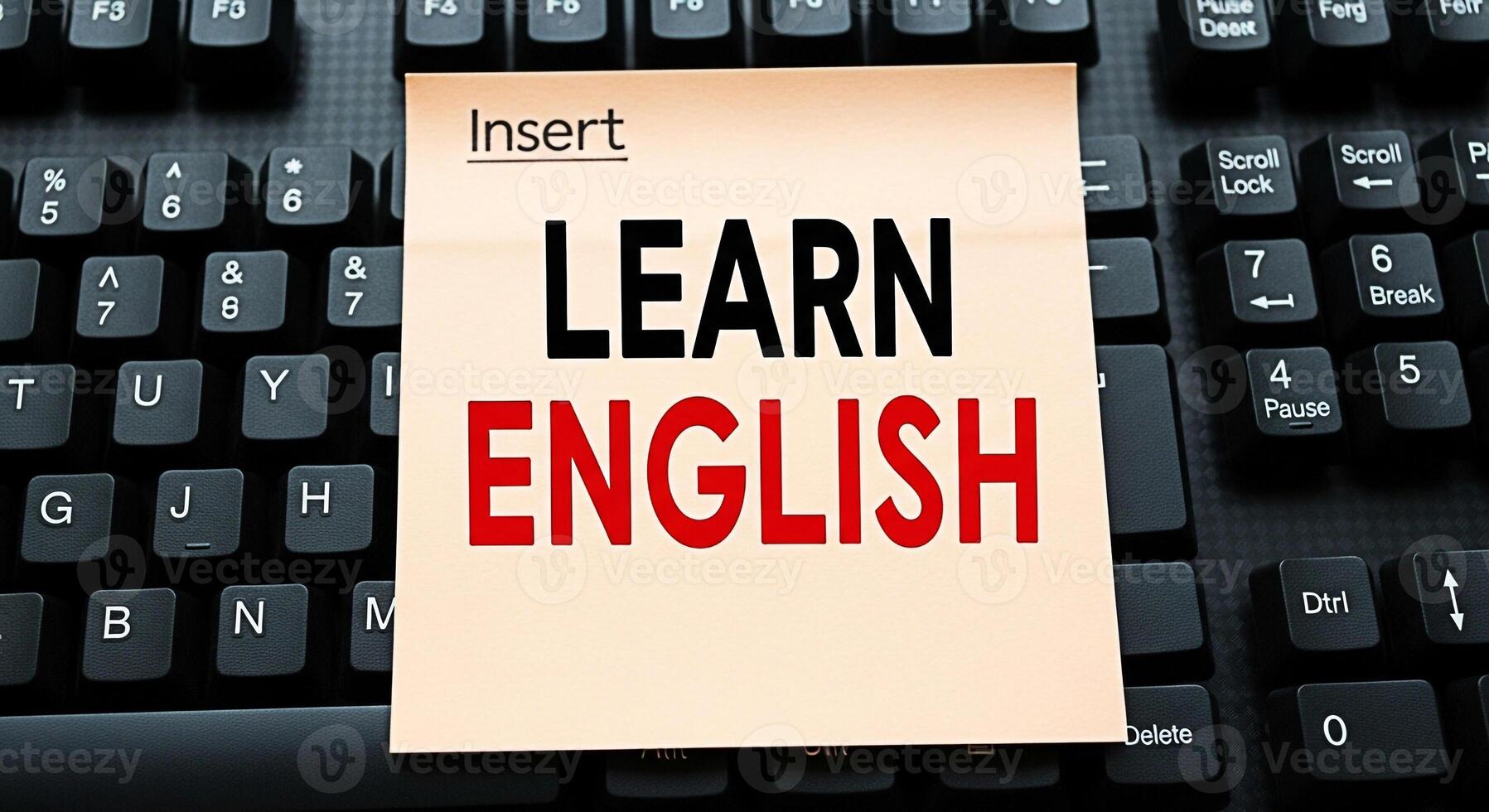 A sticky note with Learn English on a black keyboard symbolizing language acquisition in a digital environment fostering a concept of accessible education and global communication photo
