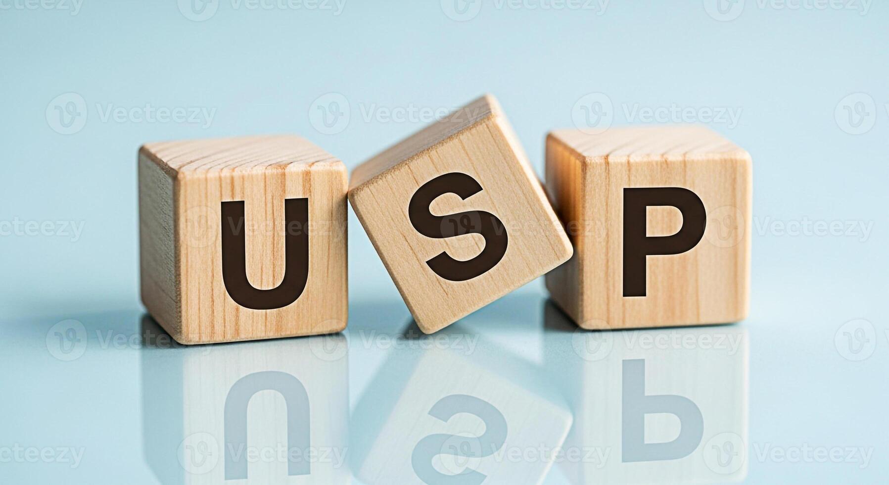Wooden blocks displaying the letters USP on a reflective surface symbolizing Unique Selling Proposition in a business context highlighting the importance of differentiation and competitive advantage i photo