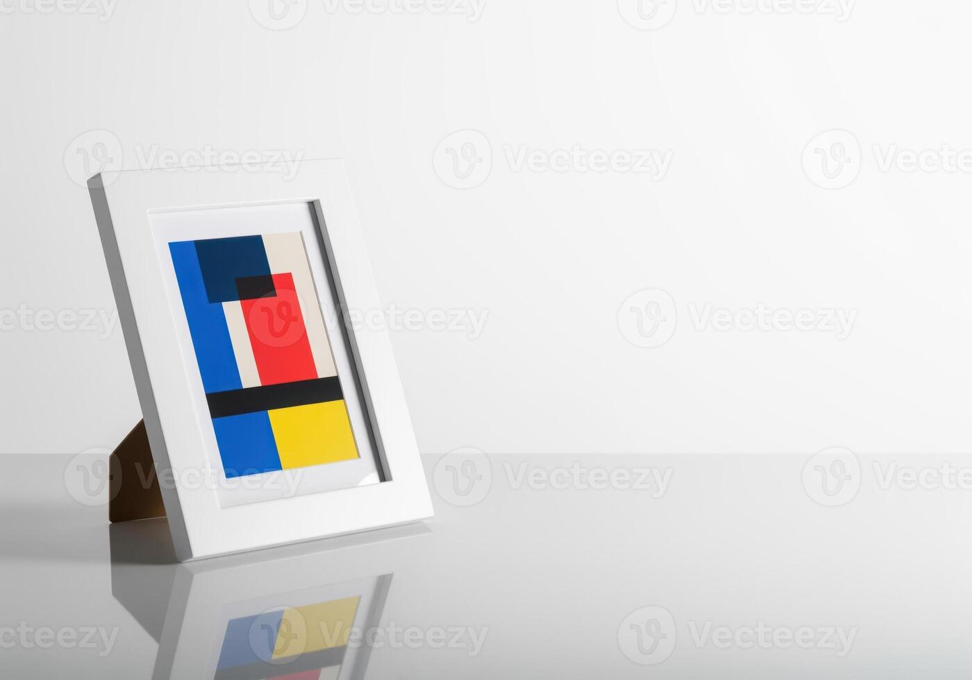 Minimalist white frame with primary color abstract art on reflective white table photo