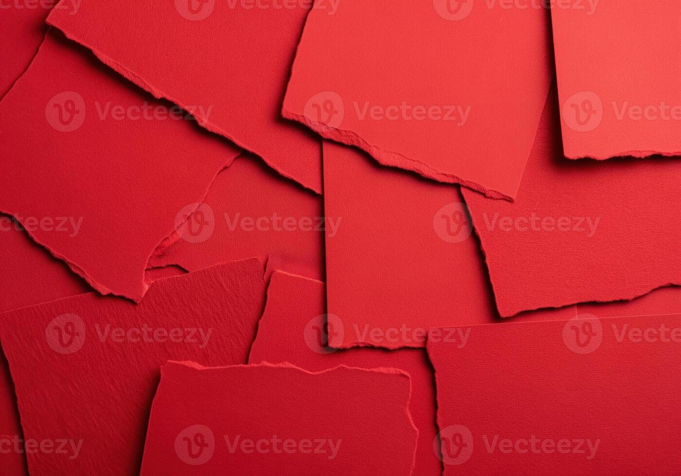 Abstract background of overlapping torn red paper pieces creating a textured crimson collage. photo