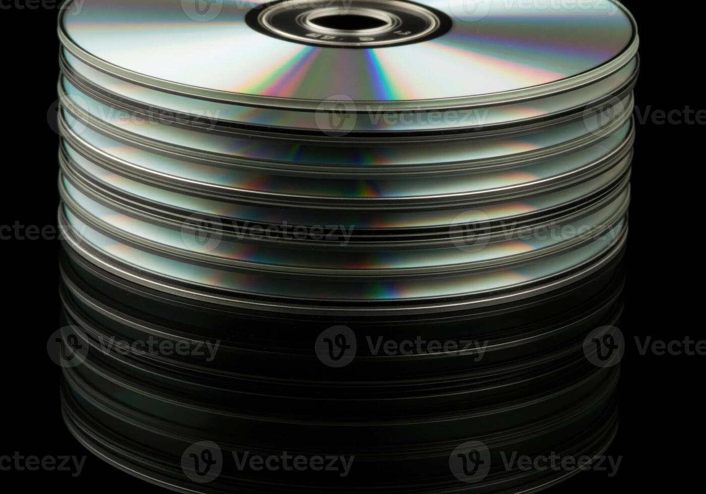 Close up of a tall stack of blank digital versatile discs reflecting rainbow light. photo