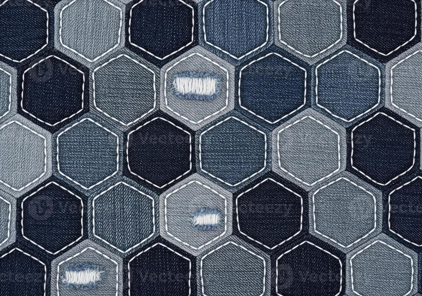 Distressed indigo denim fabric texture pattern with quilted hexagonal patches and stitching. photo