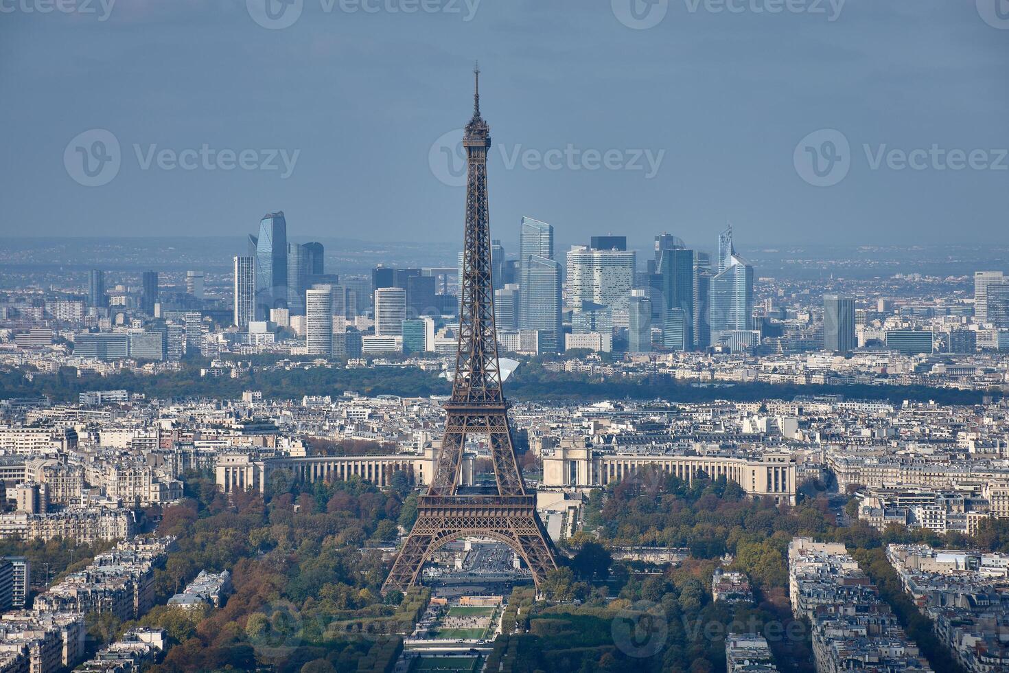 Aerial view of Paris with the Eiffel Tower in the foreground and the La Defense business district in the background on a clear day photo