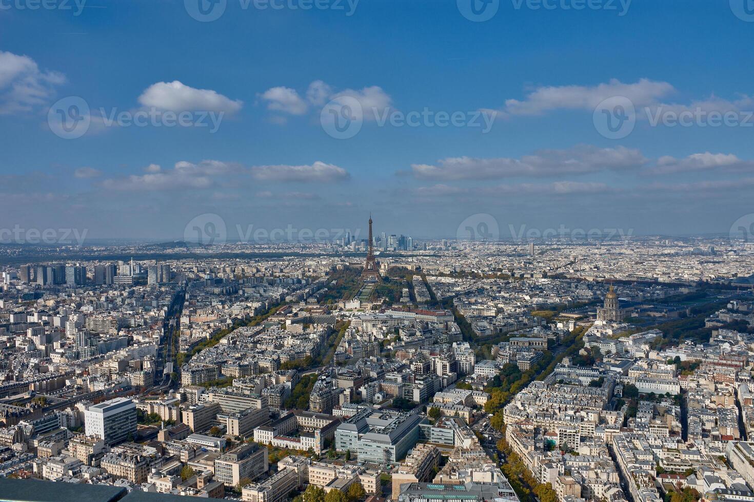 Eiffel Tower in the center of Paris with the skyscrapers of La Defense in the background, creating an architectural contrast, as seen from the Montparnasse Tower photo