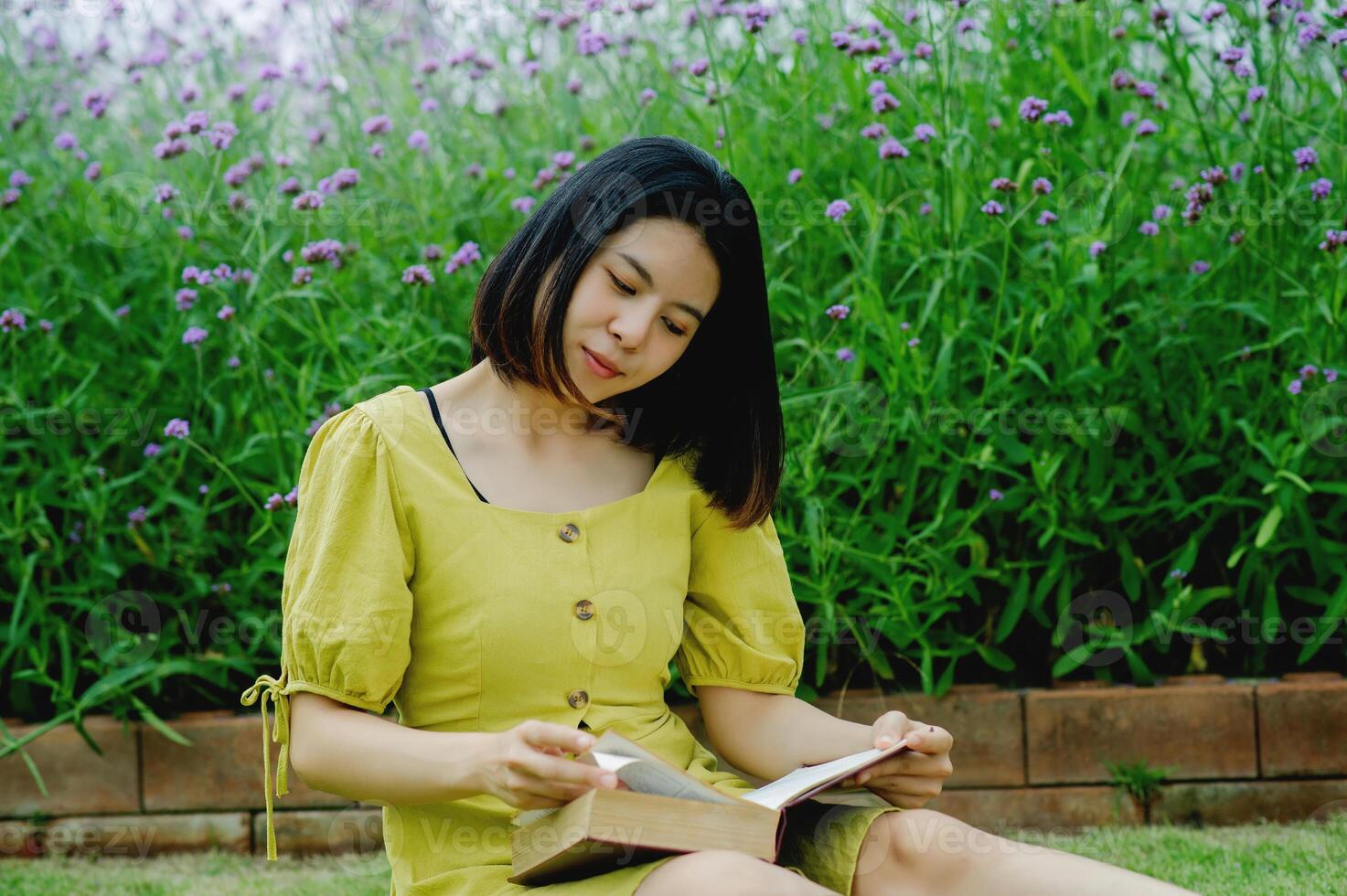 Reading in the flower garden and relaxing in oneself, learning by oneself with simple happiness photo