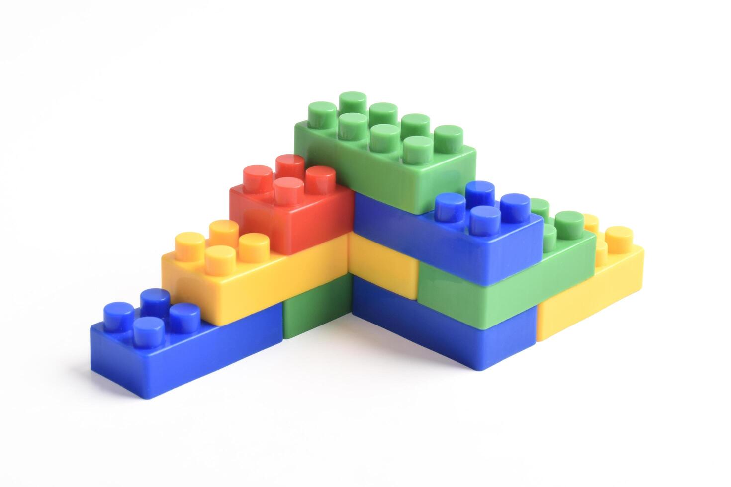 Colorful interlocking building blocks stacked in a playful, abstract structure on a white background. photo