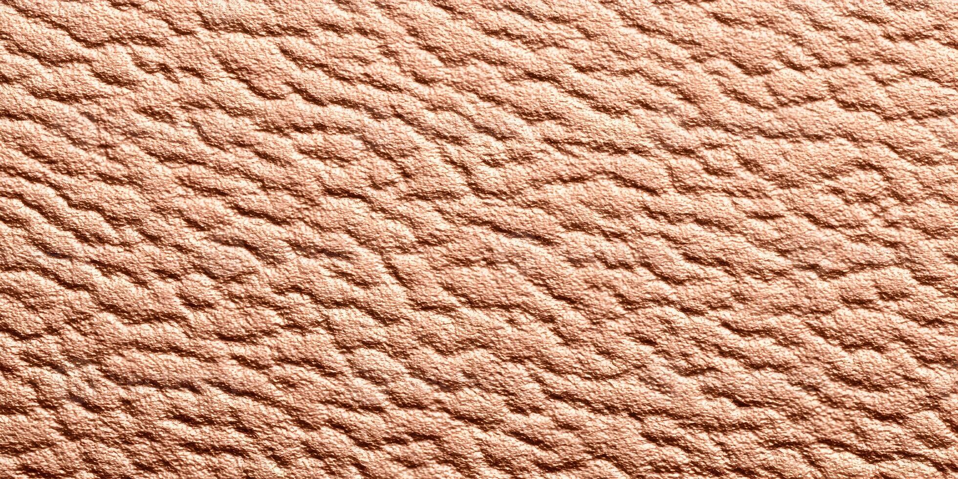A close up view of a reddish brown textured surface with an irregular wavy pattern photo