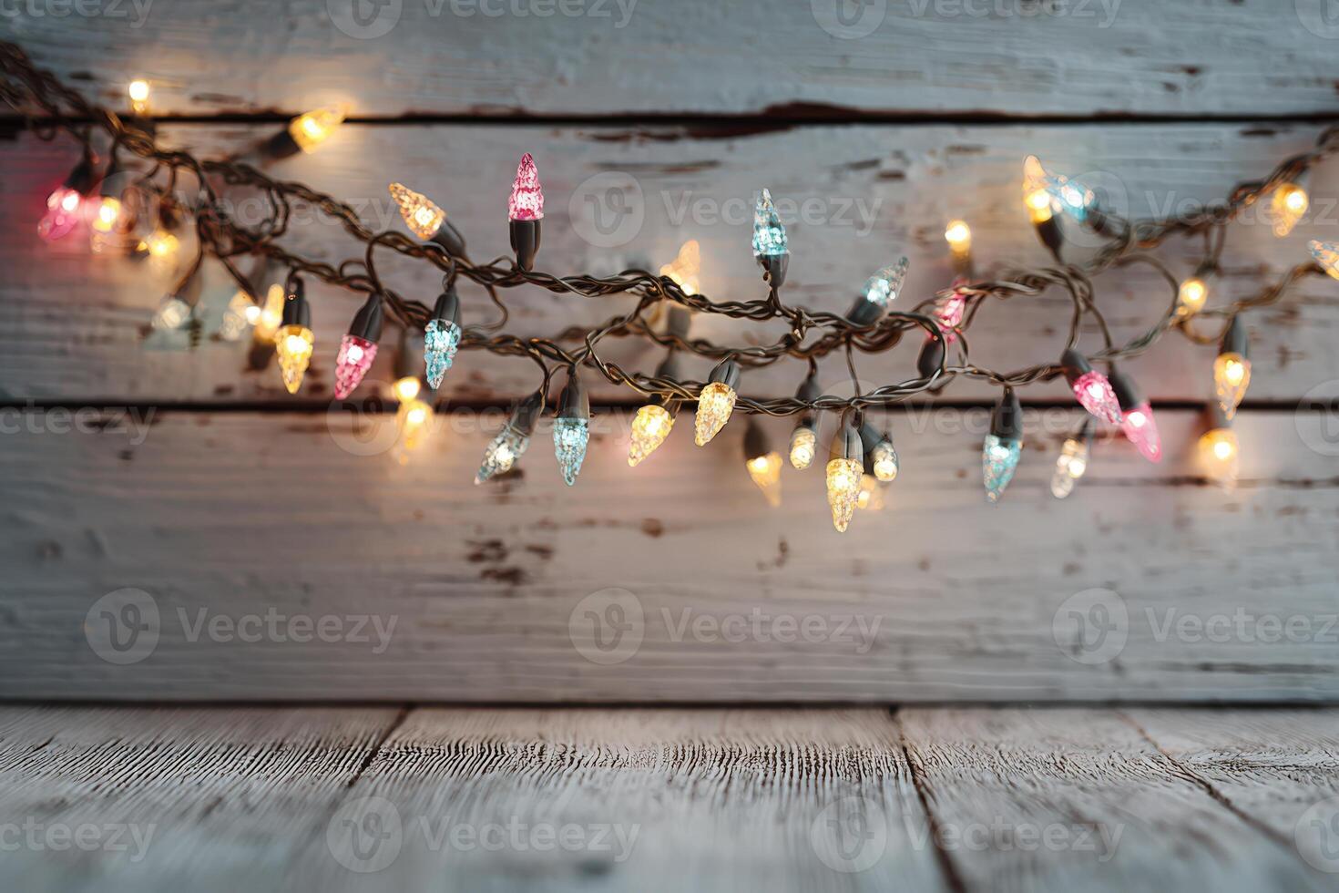 Colorful string lights with warm glow are draped over rustic wooden background, creating a cozy atmosphere perfect for festive celebrations and holiday gatherings photo