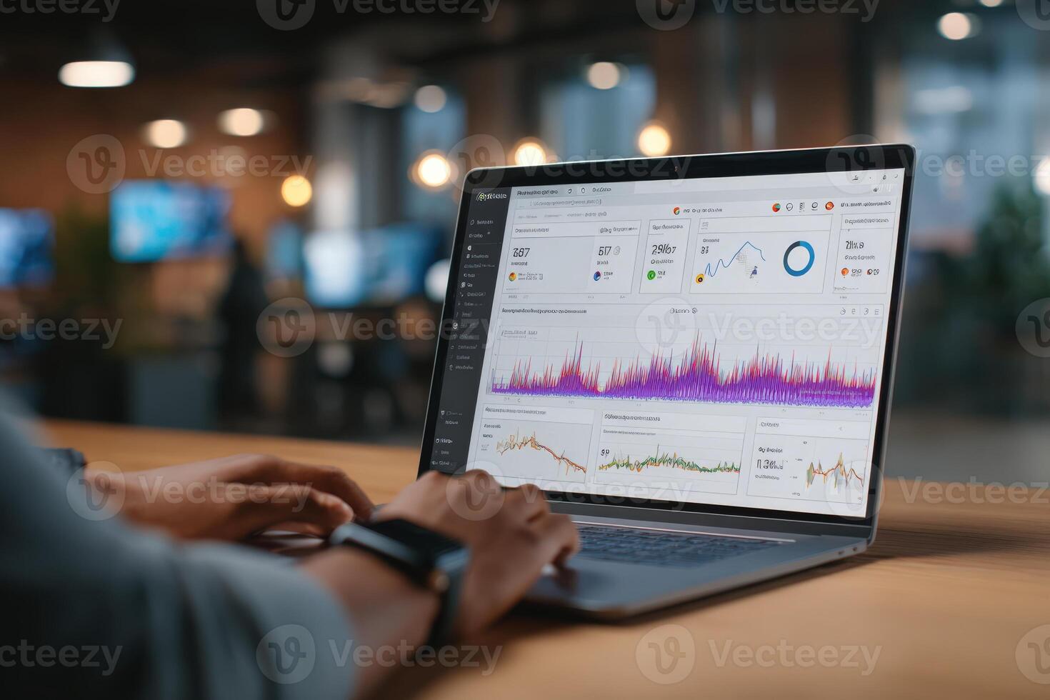 Individual analyzing data on a laptop in a modern office environment, showcasing vibrant graphs and charts on the screen, emphasizing digital analytics and productivity photo