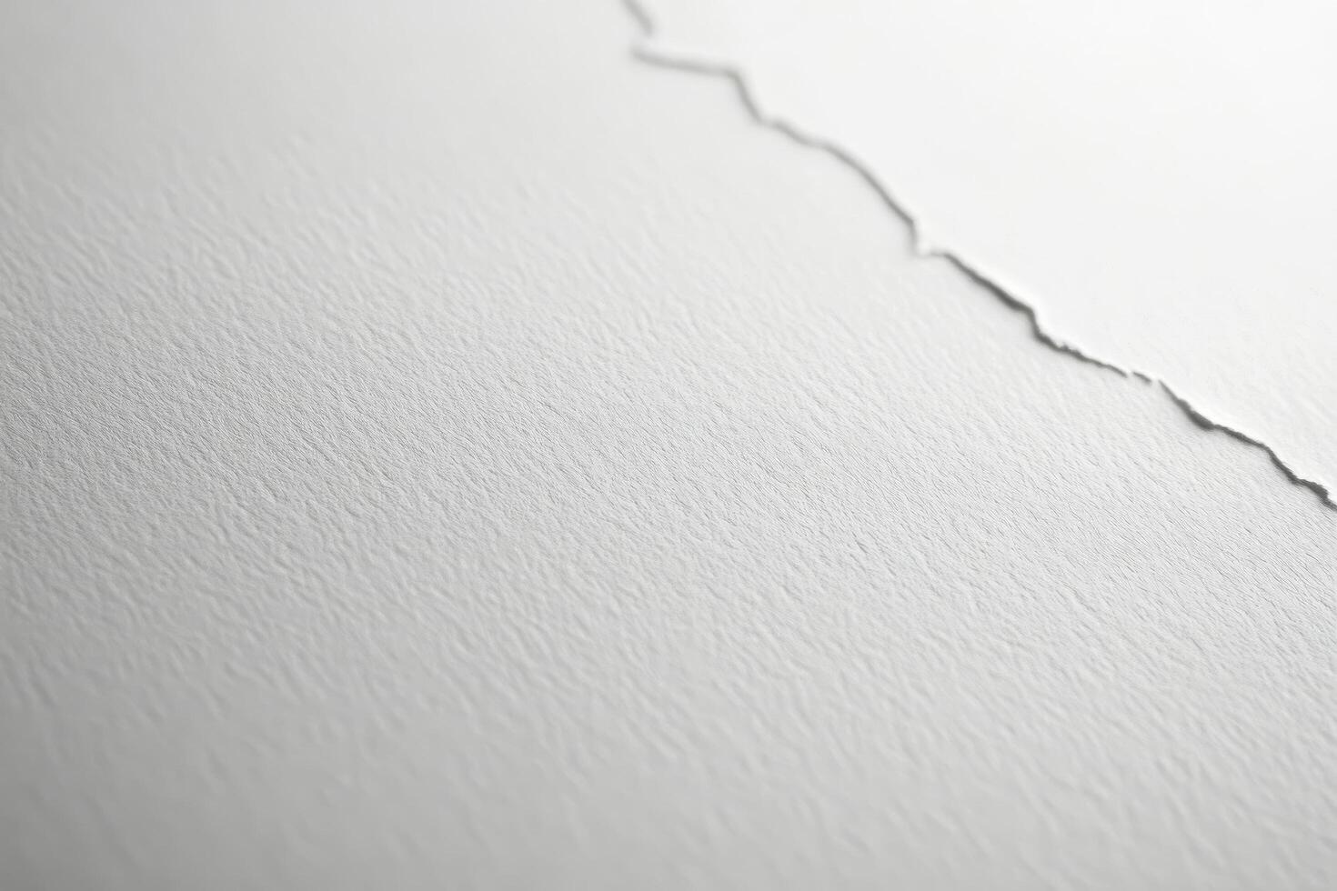 White torn paper with textured surface creating a minimalist design in a well-lit environment. photo
