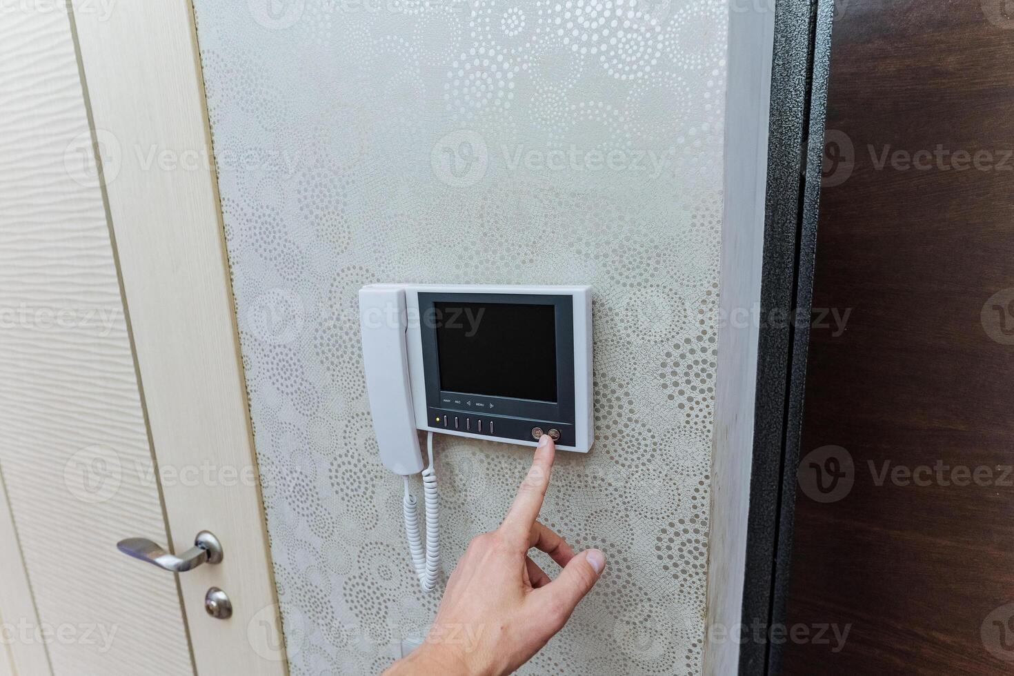 intercom used for visitor verification, user utilizes intercom to confirm visitor before entry photo