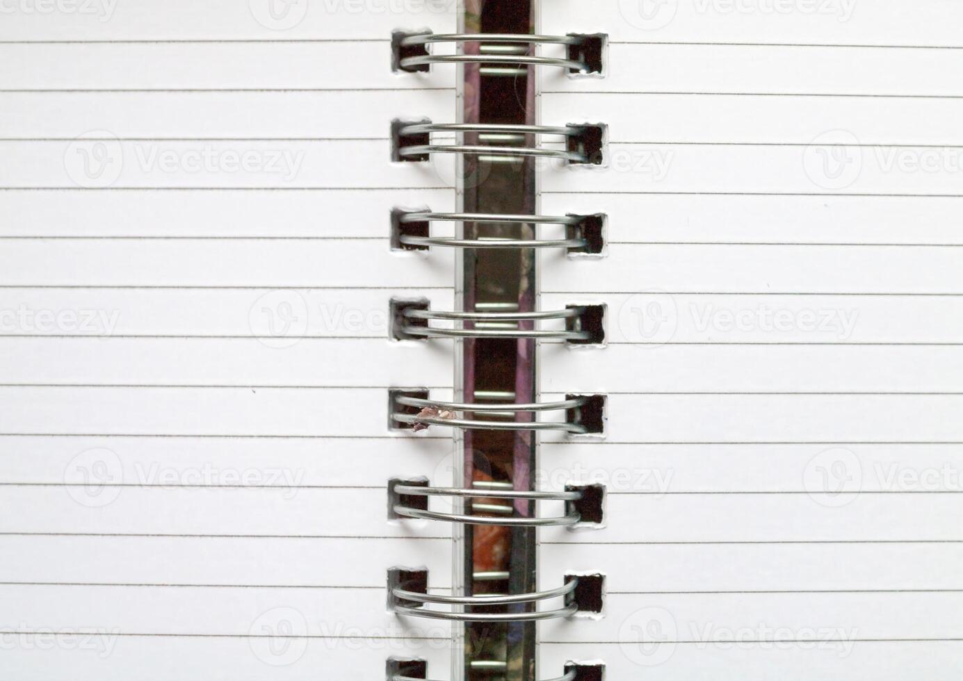 A CloseUp Image Showing the Binding of a Spiral Notebook, Capturing Its Intricate Details. photo