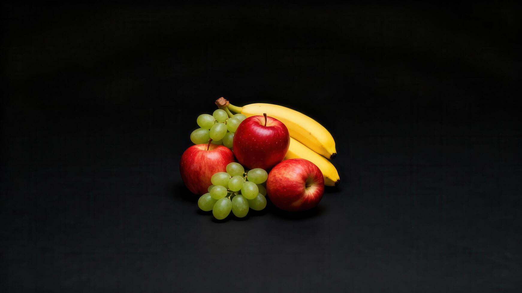 Assortment of fresh fruit including bananas, red apples, and green grapes arranged on a dark surface photo