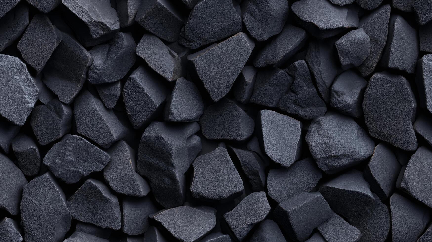 A close-up view of a textured surface composed of many dark gray, jagged rocks, creating a visually interesting and solid pattern. photo