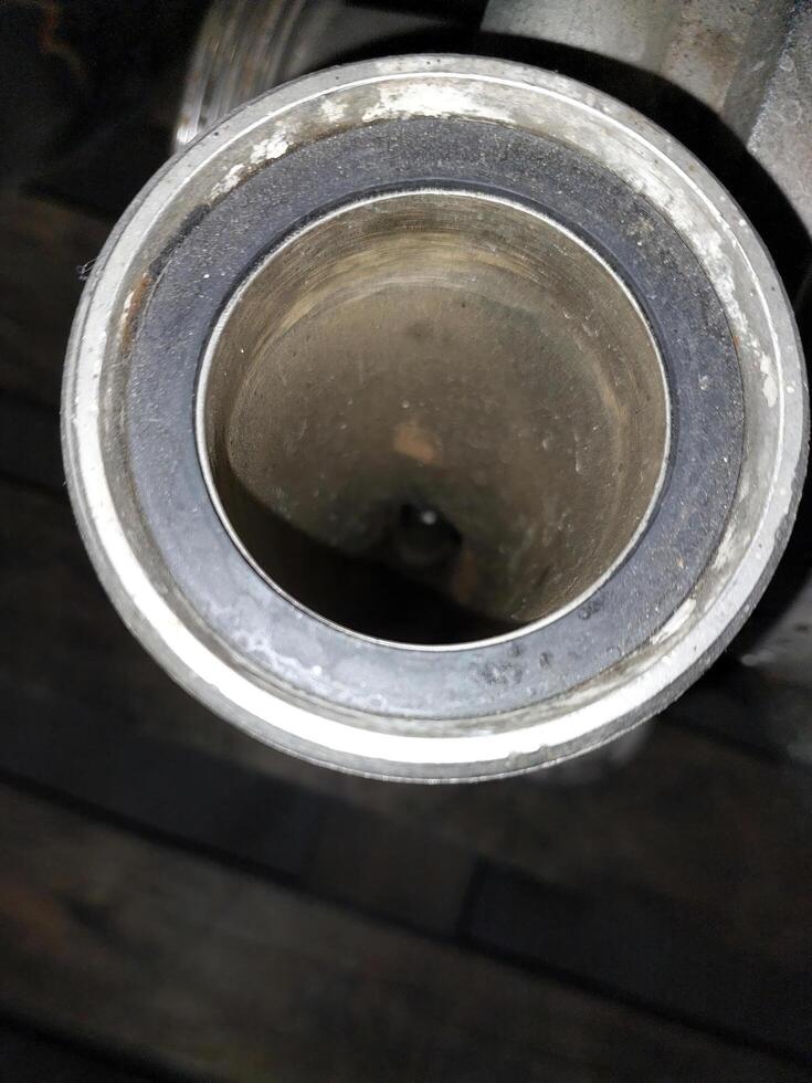 Exploring the Intricate Design of a Stainless Steel Pipe Fitting in a Workshop Setting photo