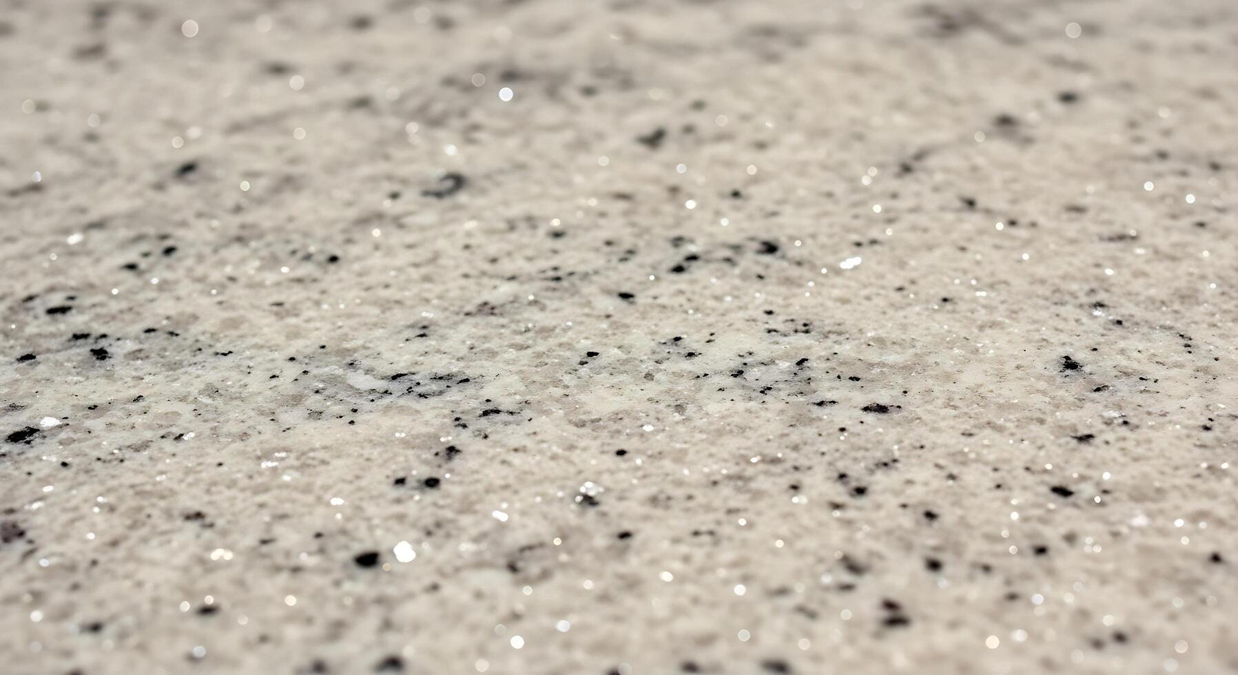 Close up of sparkling white and black glitter particles creating a textured abstract background effect photo