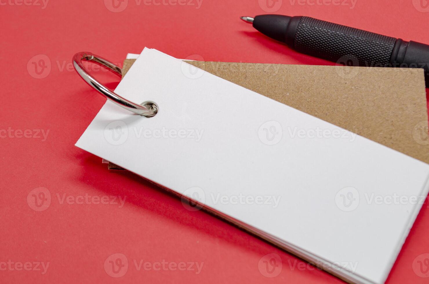 White banner shape notepad with customizable space for text on red background. photo