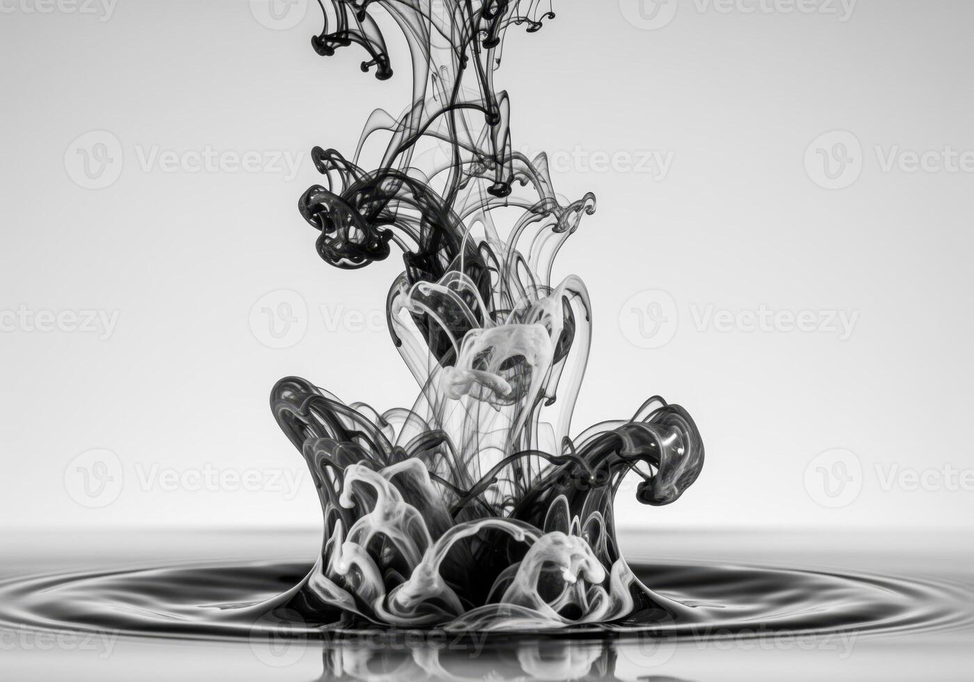 Dynamic black and white ink collision in water creating abstract swirling plumes. photo