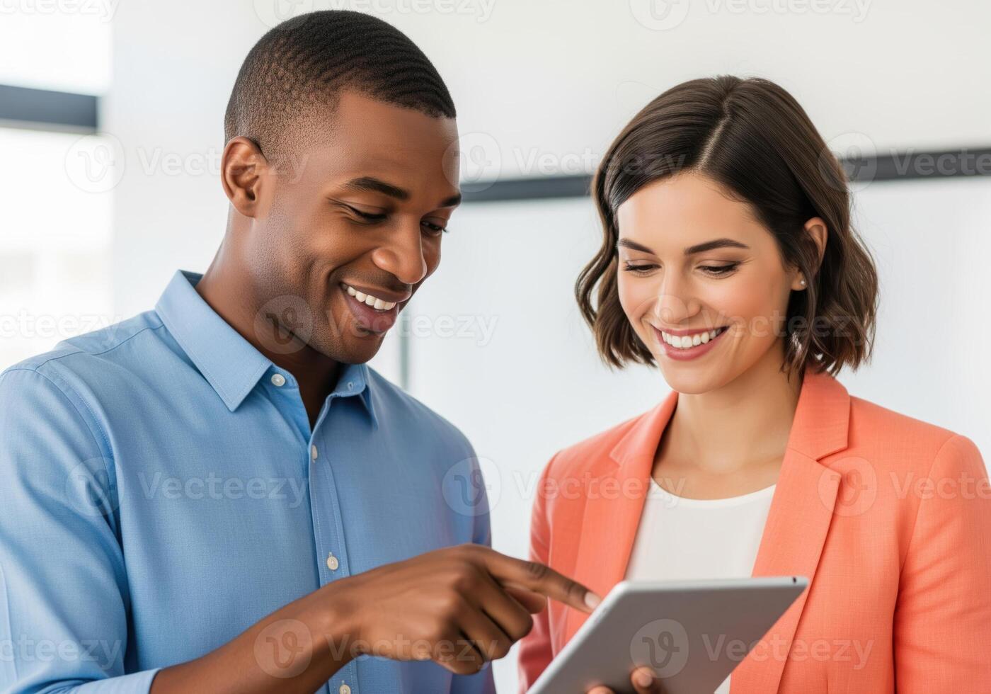 Diverse business team smiling while collaborating and using a tablet computer device. photo