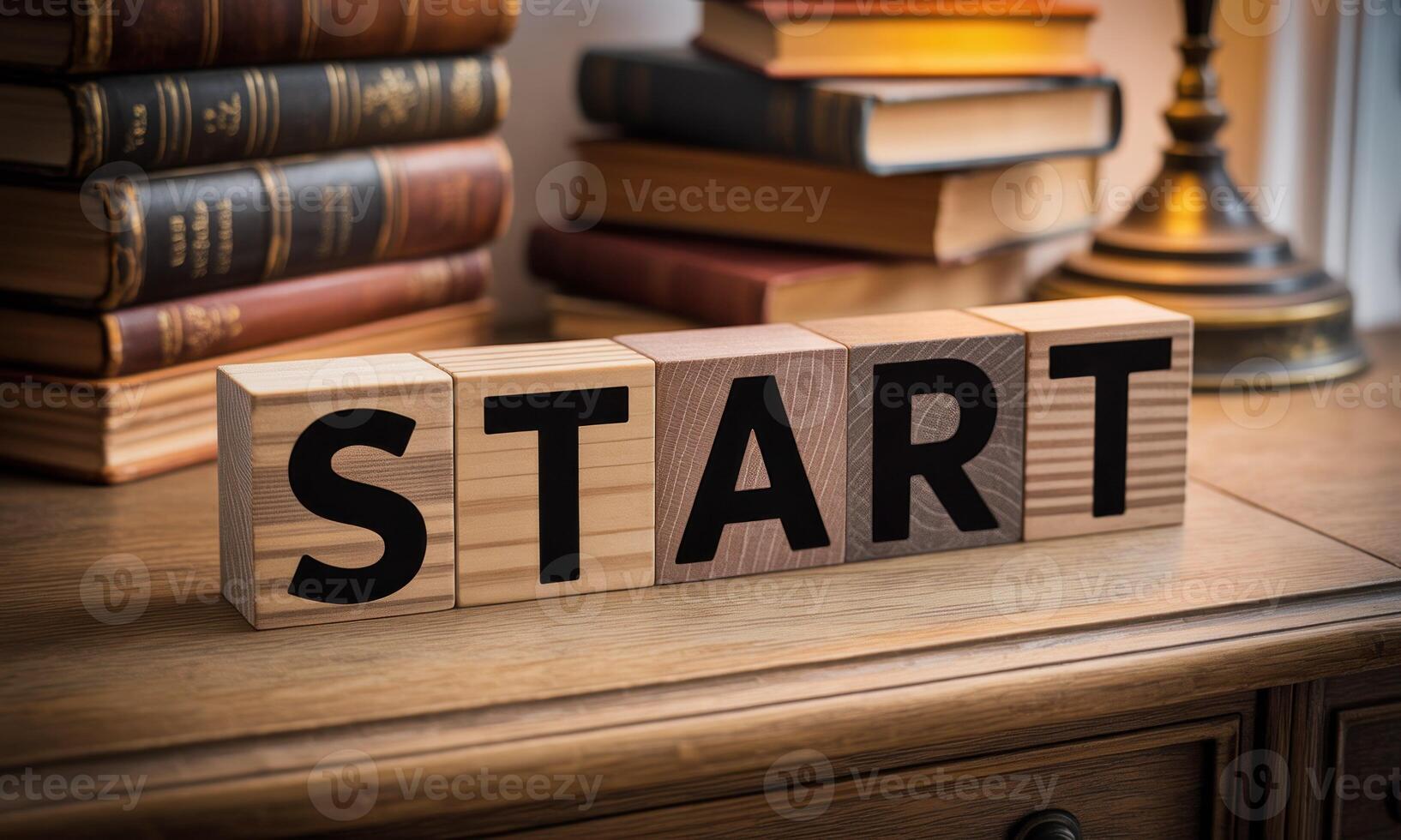 Start block word on wooden table with books and lamp photo