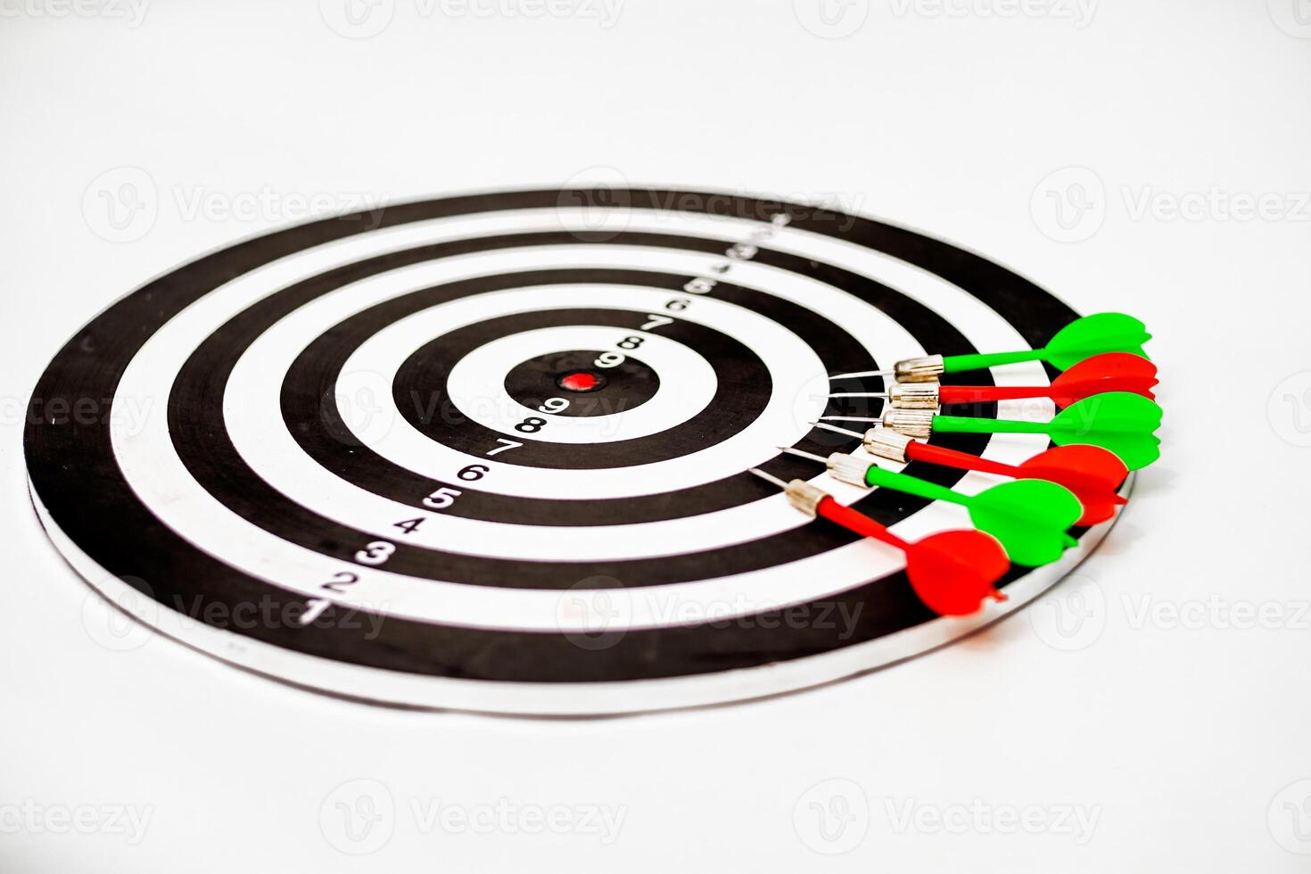 Dartboard with multiple darts hitting the target, symbolizing accuracy and precision photo