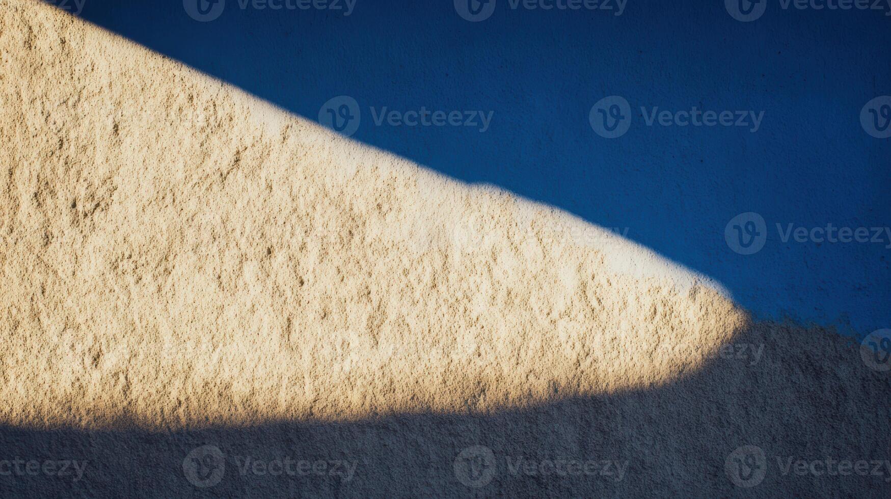 Soft shadows create patterns on textured wall surface photo