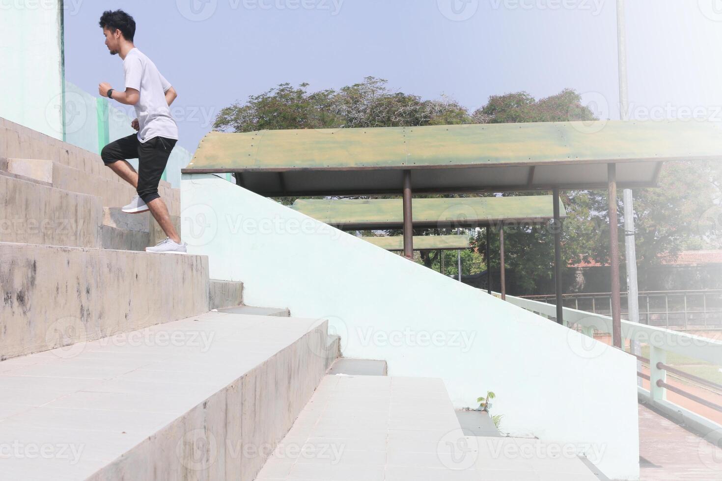 A man is running up a set of stairs. Concept of determination and, physical exertion. photo
