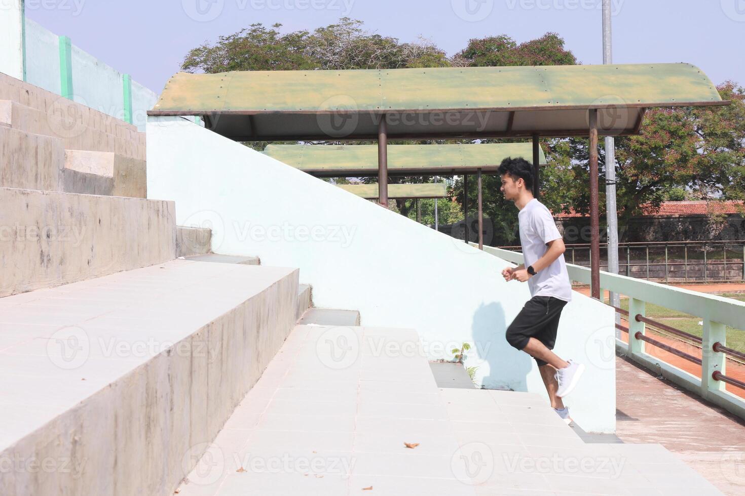 A man is running up a set of stairs. Concept of determination and, physical exertion photo