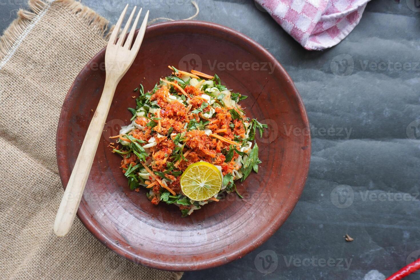 Trancam is a traditional salad from Java, Indonesia made from fresh vegetables such as cucumber, basil, long beans, and white cabbage, which are cut into pieces, photo