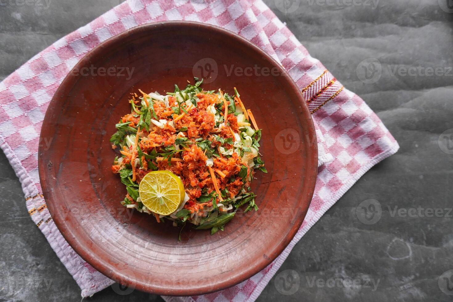 Trancam is a traditional salad from Java, Indonesia made from fresh vegetables such as cucumber, basil, long beans, and white cabbage, which are cut into pieces and mixed with photo