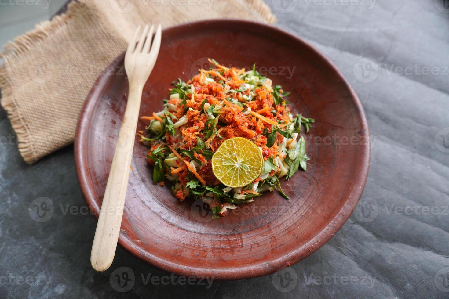 Trancam is a traditional salad from Java, Indonesia made from fresh vegetables such as cucumber, basil, long beans, and white cabbage, which are cut into pieces. photo