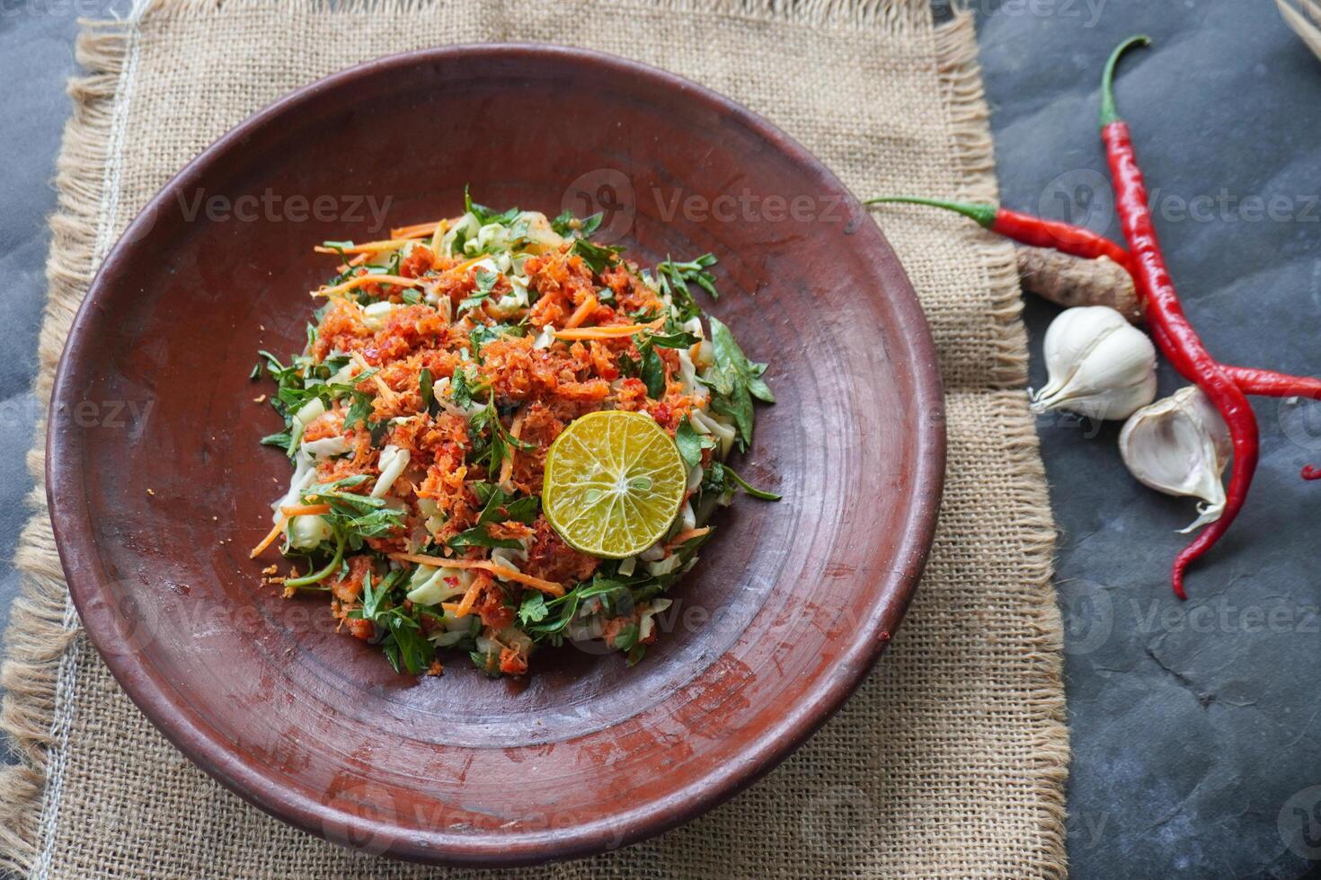 Trancam is a traditional salad from Java, Indonesia made from fresh vegetables such as cucumber, basil, long beans, and white cabbage, which are cut into pieces and mixed with grated coconut. photo