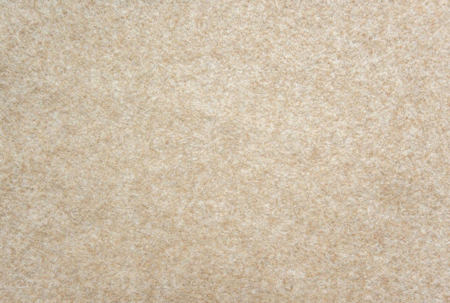 Beige felt texture background. Soft fabric surface with fuzzy fibers, warm neutral textile material for design or craft backdrop. photo