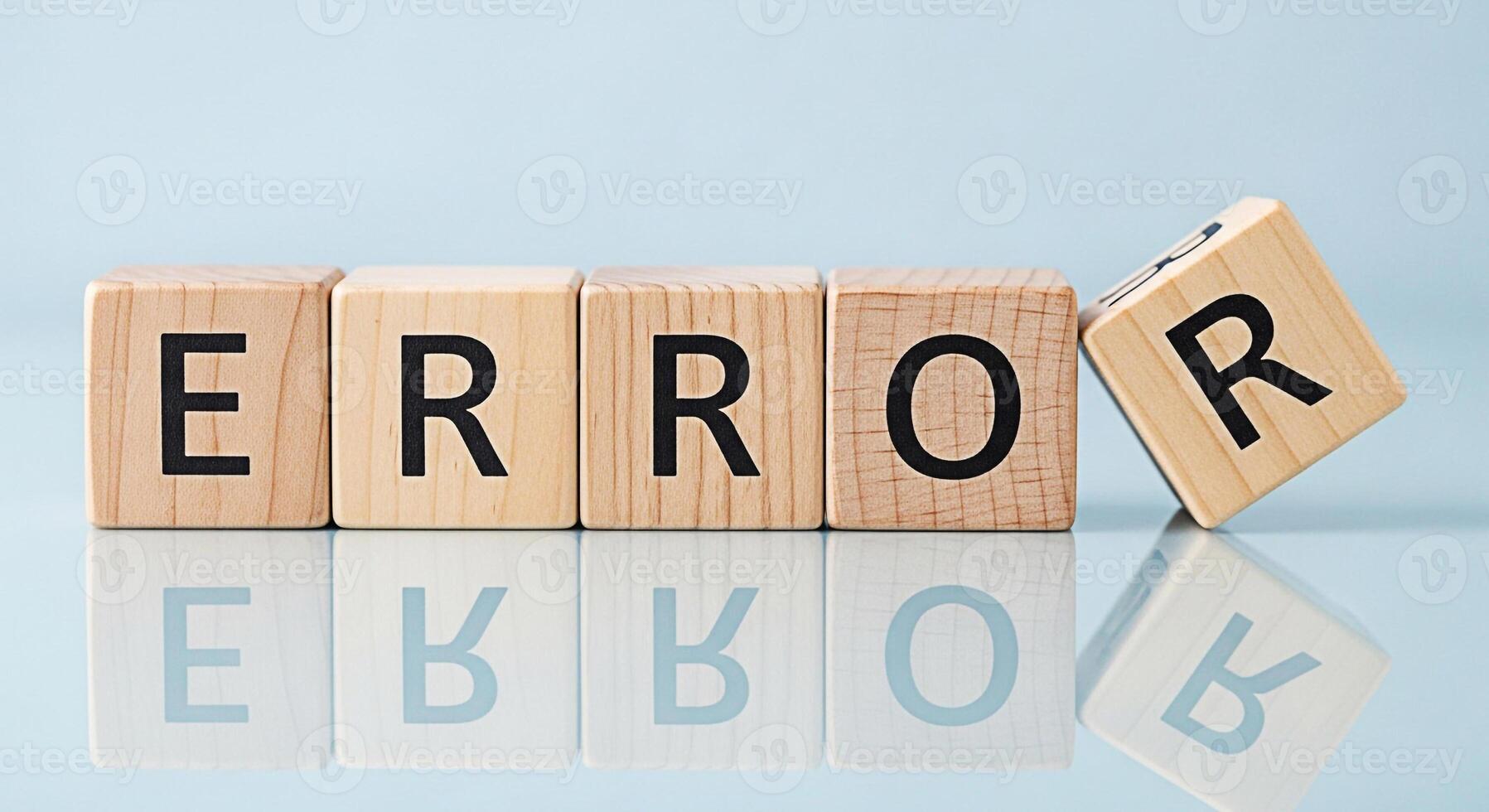 Wooden blocks spelling ERROR on a reflective surface with one block tilted symbolizing system failure software bug or a critical mistake in a clean minimalist setting creating a sense of urgency and c photo