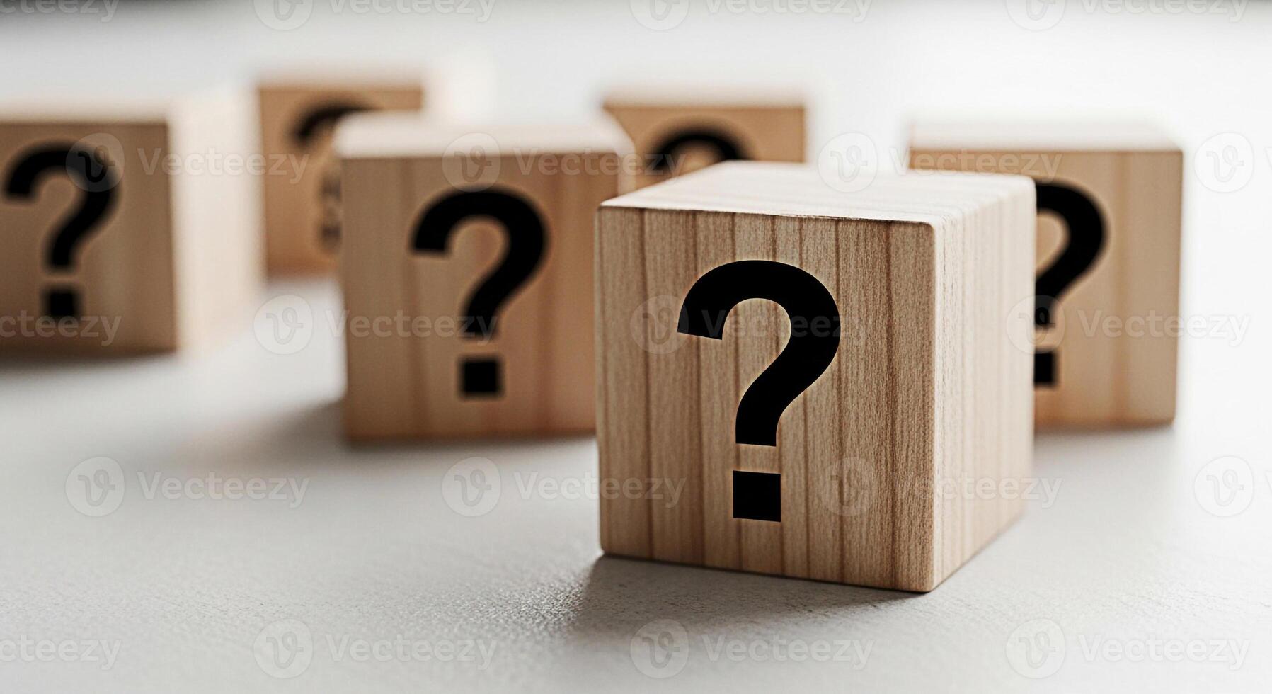 Wooden blocks displaying question marks on a white surface symbolizing uncertainty and the need for answers in a clean minimalist setting creating a sense of curiosity and problemsolving photo
