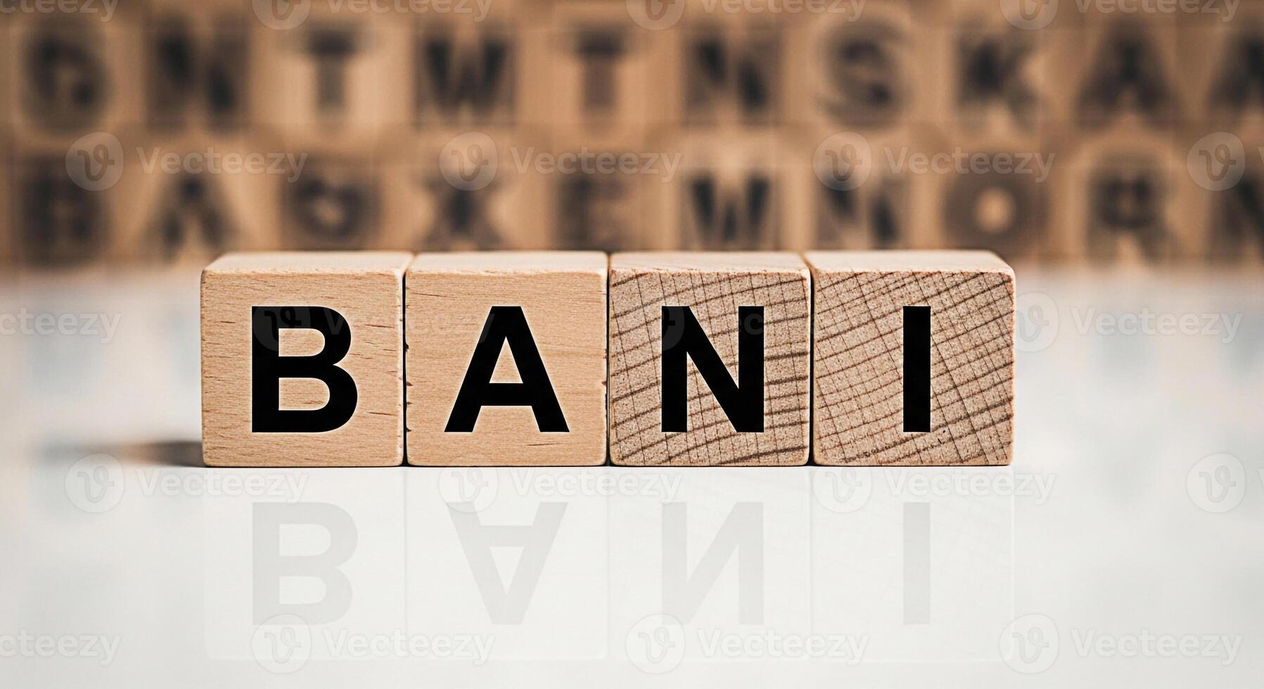 Wooden blocks spelling out BANI on a reflective surface conveying a sense of simplicity and focus in a learning environment ideal for educational materials and language development resources photo